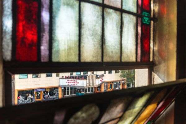 Carlisle Theater seen through the stained glass windows of the Odd Fellows Hall in Carlisle Pennsylvania