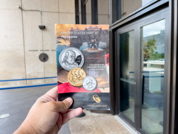 Holding a booklet outside of the Philadelphia Mint.