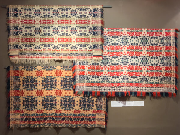 Three coverlets hanging on the wall at the National Museum of the American Coverlet in Bedford County PA
