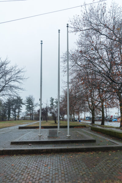 Three empty flagpoles in Penn Landing Site in Chester, Pennsylvania