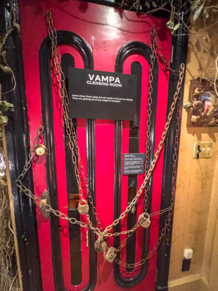 Padlocked door with a sign about dark energy at the VAMPA Museum in Pennsylvania