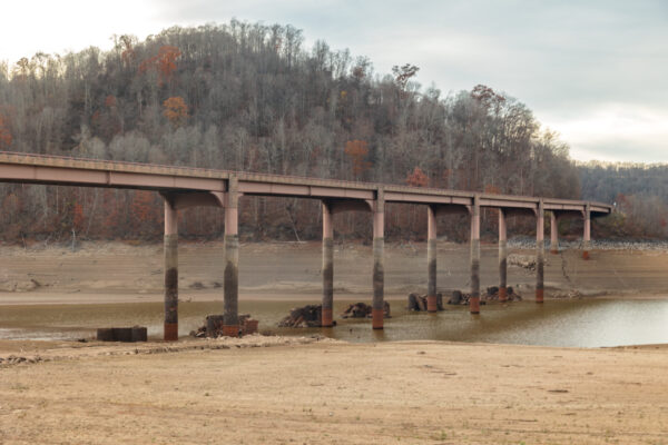 The modern Route 40 bridge sits high above the water with ruins below it in Somerset County PA