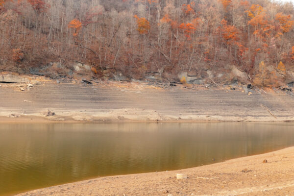 Dry lake bed with fall trees near the Great Crossings Bridge in the Laurel Highlands