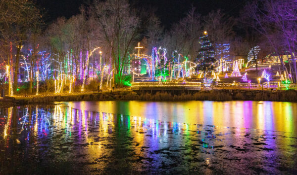 Lights are reflected in a pond at the Christmas Light Experience at Refreshing Mountain PA