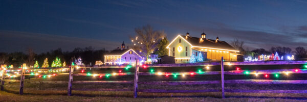 Lit barn and fencing during Christmas at Stone Gables Estate in Lancaster County PA