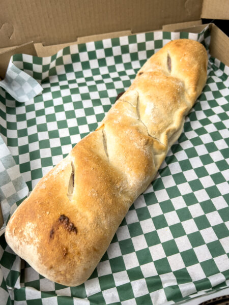 A stromboli from Romano's in Delaware County, PA on checkerboard paper.