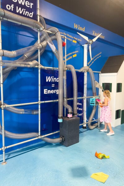 Girl plays with pneumatic tubes at the Bucks County Childrens Museum in PA 