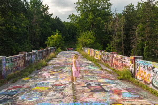 Young girl in a pink dress standing on Graffiti Bridge in Berks County PA