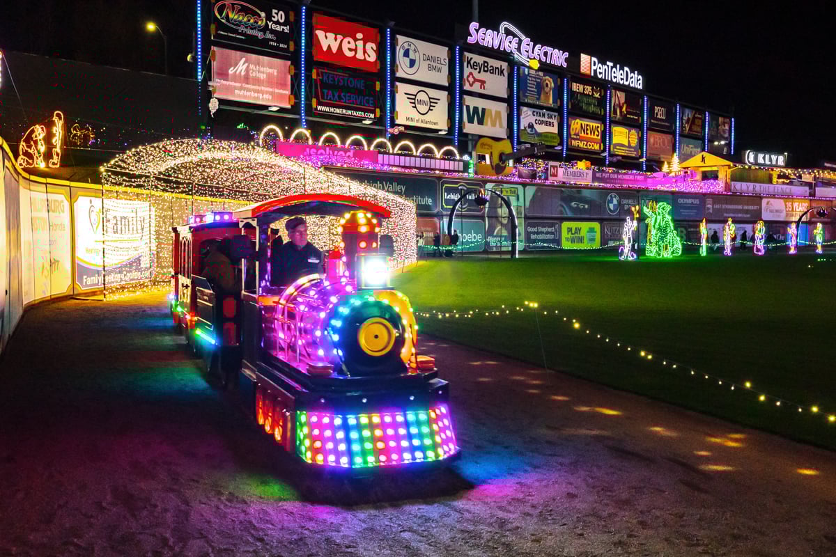 A train passes under a light tunnel at Illumination at Coca-Cola Park in Allentown PA