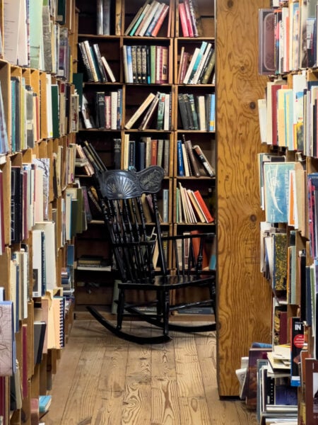 A rocking chair at the end of a bookshelf at Baldwin's Book Barn in southeastern PA