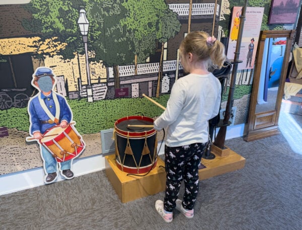Child playing a drum at the Children of Gettysburg 1863 Museum in Gettysburg PA