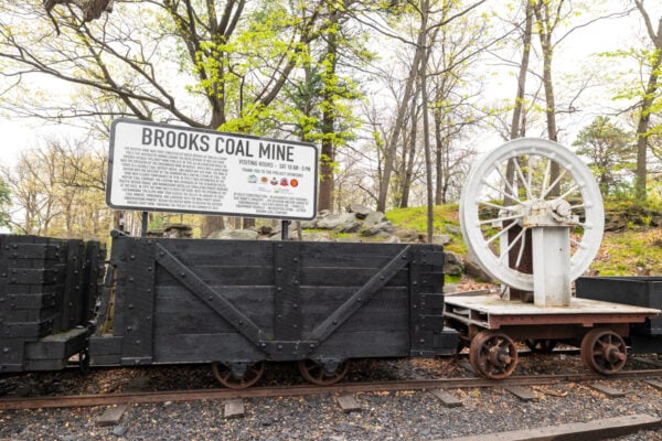 Old coal car and signage sitting outside of the Brooks Mine in Scranton, Pennsylvania