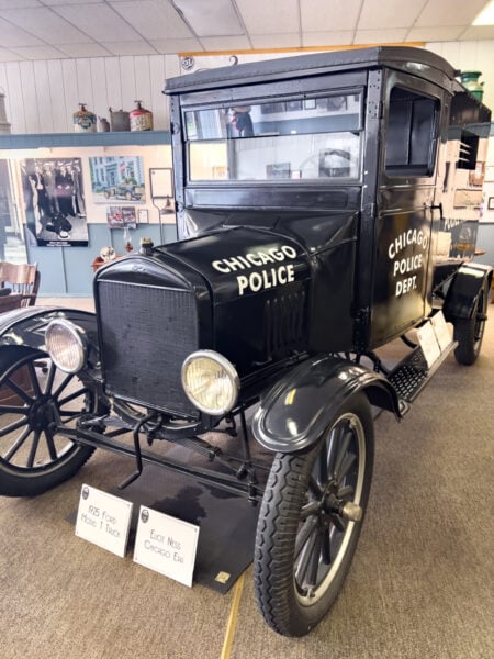 A black 1920s car on display inside the Eliot Ness Museum in Coudersport Pennsylvania