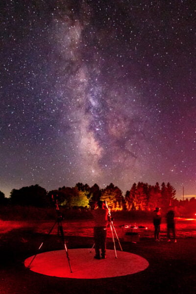 Man using a telescope in front of the Milky Way at Cherry Springs State Park in Potter County, Pennsylvania