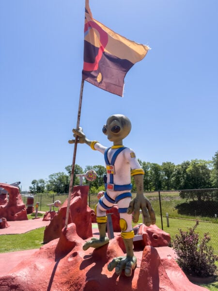 Alien holding a flag on the Cornhole Golf course in Mars Pennsylvania