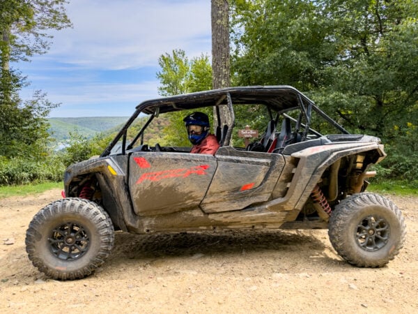 Man sitting in a Polaris ATV at Lyman Run State Park in Potter County PA