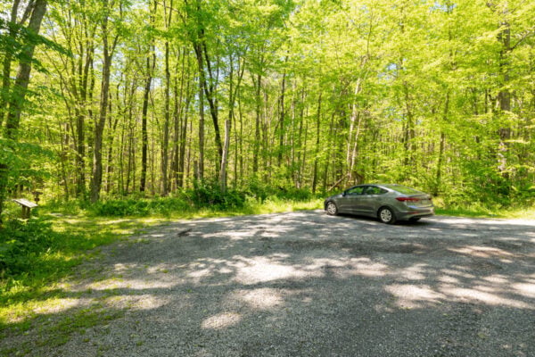 Gravel parking area with a single car in Gallitzin State Forest in Somerset County Pennsylvania