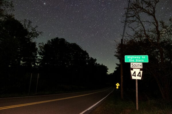 Forested road next to a sign that says Highway to the Stars in Potter County PA